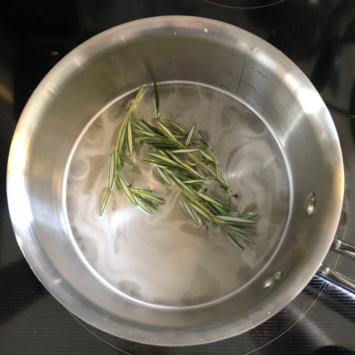 fresh rosemary in a pot with simply syrup