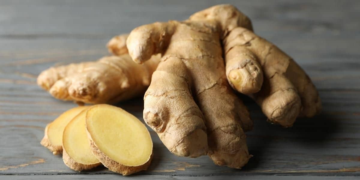 whole and sliced fresh ginger on cutting board
