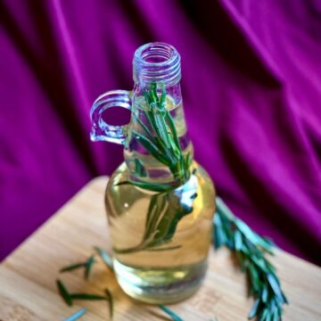Rosemary simple syrup on a cutting board.