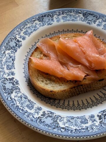 toast with smoked paprika mayo and salmon on a plate