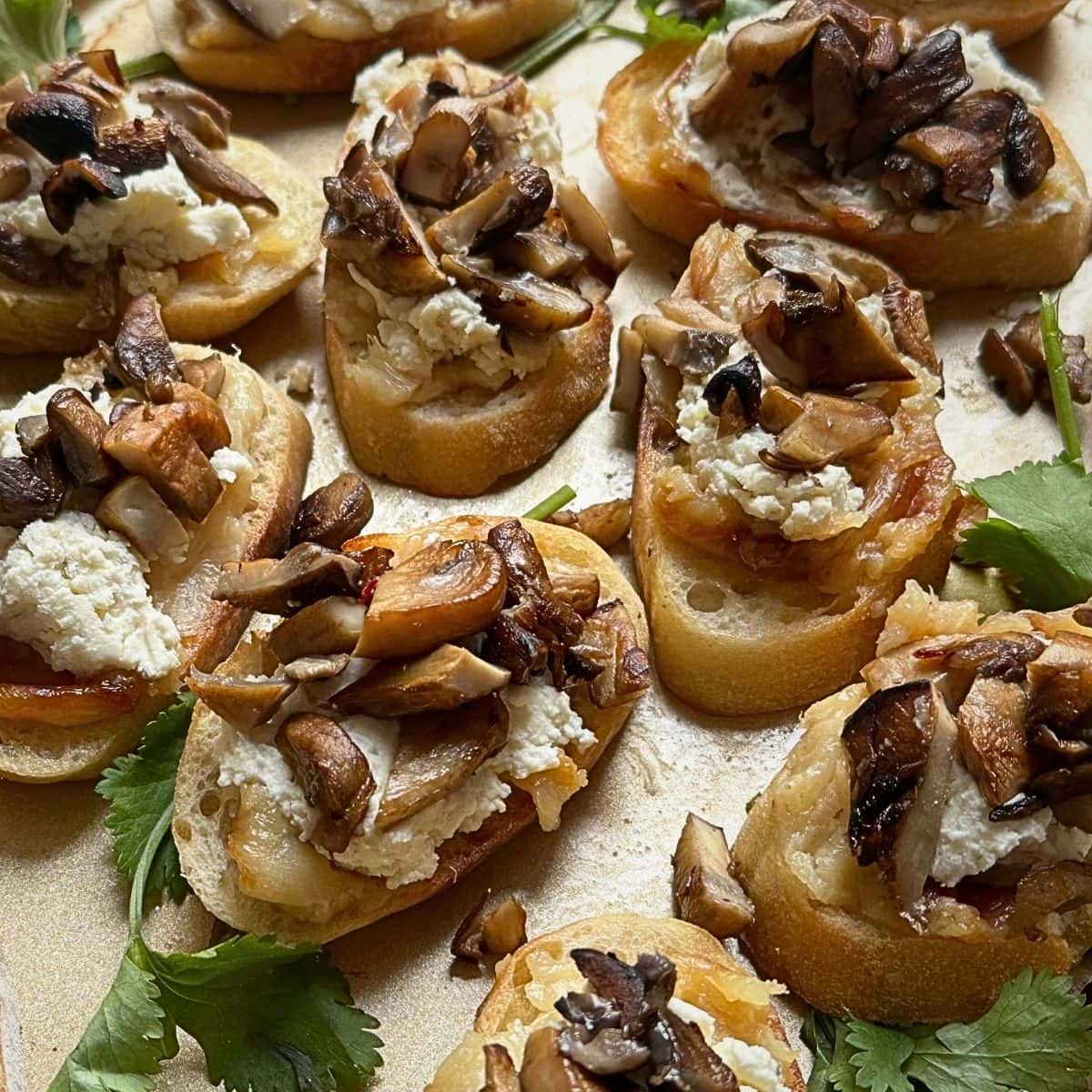 Mushroom and roasted garlic crostini on baking sheet