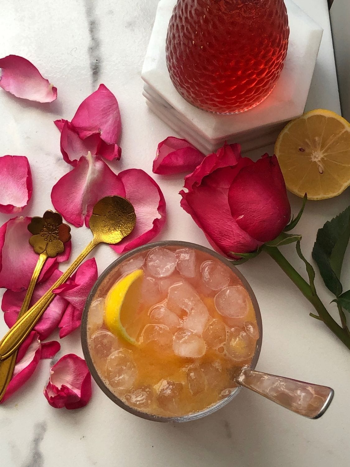 Overhead shot of a Peach Rose Lemonade on a marble top.