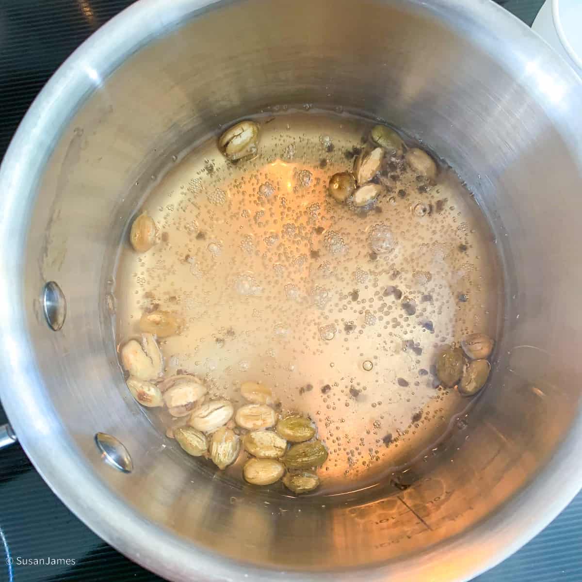 cardamom pods simmering in water