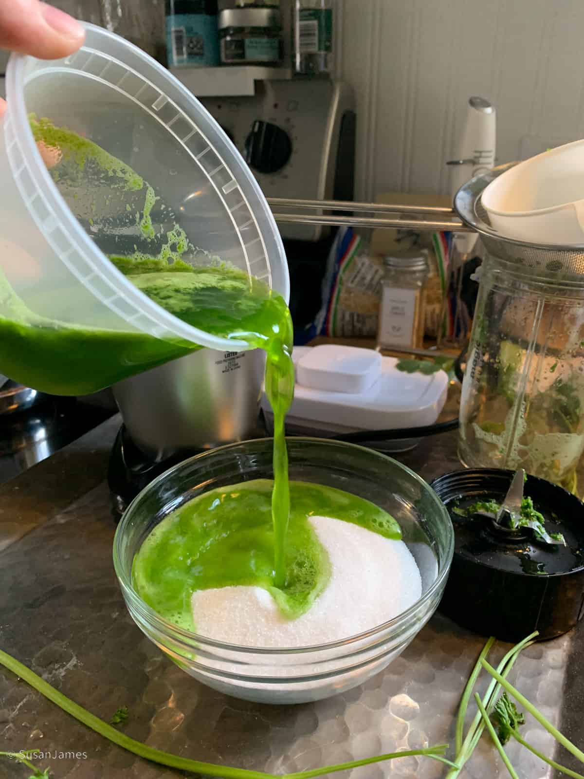 parsley water being poured into a small bowl with sugar.