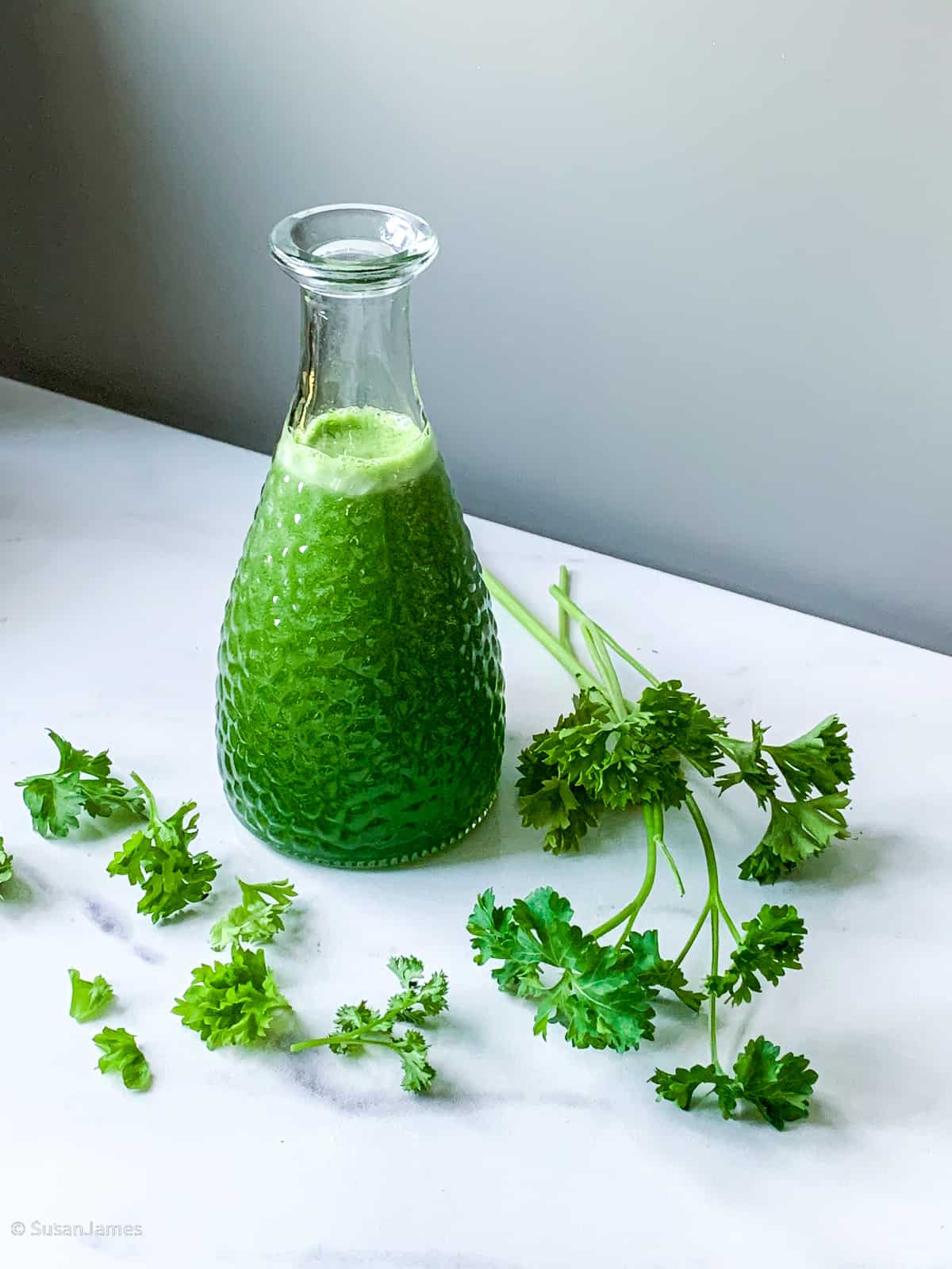parsley simple syrup on a marble board