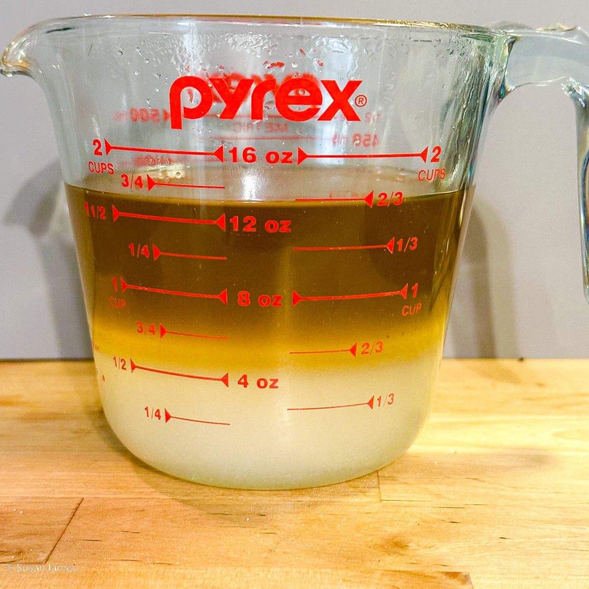 ginger water and sugar in a liquid measuring cup